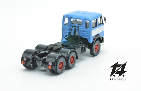 697 3-axle mounted light blue tractor truck with black chassis and white band