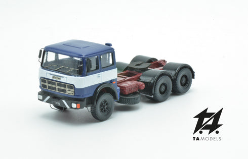 697 3-axle truck mounted on a blue tractor with a red chassis and white band