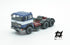 697 3-axle truck mounted on a blue tractor with a red chassis and white band