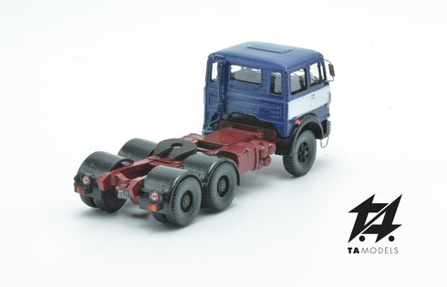 697 3-axle truck mounted on a blue tractor with a red chassis and white band