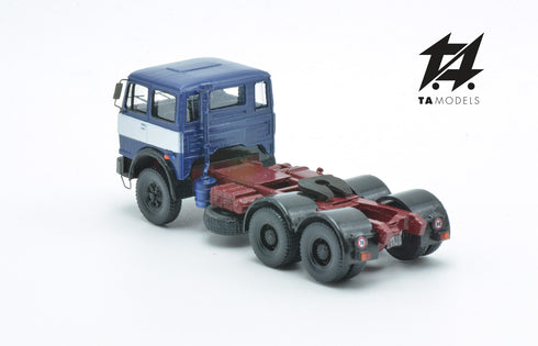 697 3-axle truck mounted on a blue tractor with a red chassis and white band