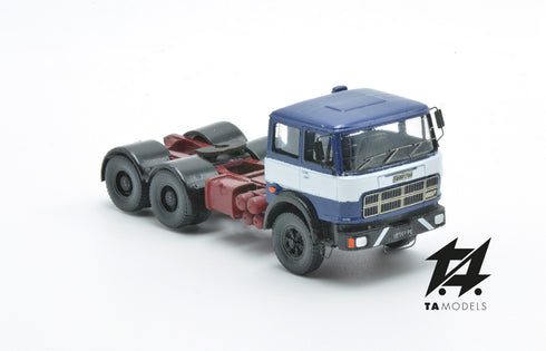 697 3-axle truck mounted on a blue tractor with a red chassis and white band